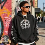 Stylish individual showcasing Chrome Hearts hoodie and accessories in urban setting